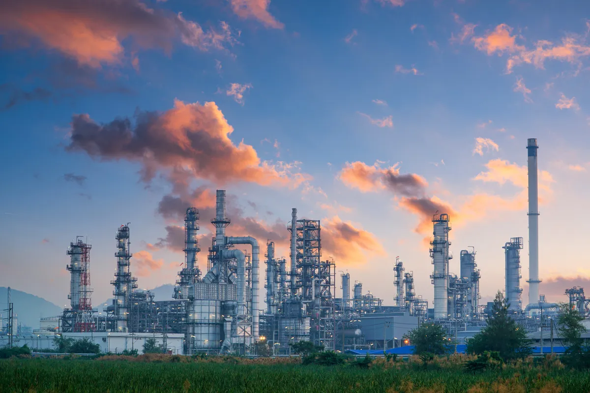 Chemical process plant with distillation towers at dusk